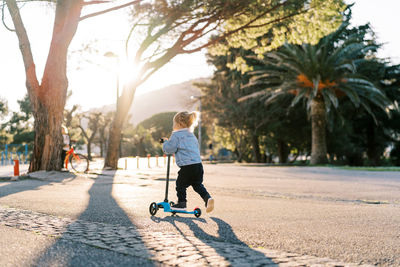 Rear view of boy walking on street