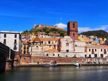 View of the colourful town of bosa in sardinia with the hilltop castle of serravalle