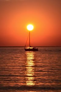 Scenic view of sea against orange sky