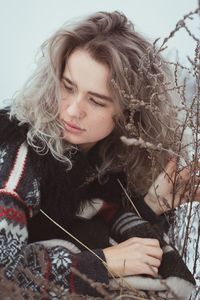 Close up thoughtful woman in sweater on winter meadow portrait picture