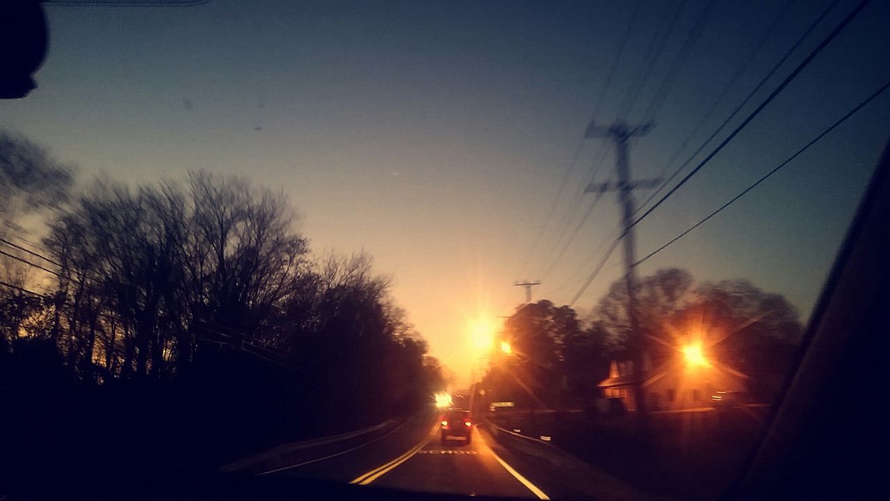 transportation, car, mode of transport, land vehicle, road, sunset, the way forward, electricity pylon, clear sky, silhouette, power line, on the move, windshield, travel, vehicle interior, diminishing perspective, sky, street, street light, transparent