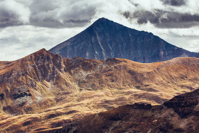 Scenic view of mountain against cloudy sky