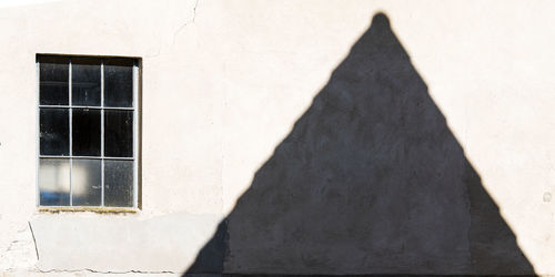 Shadow of people on wall of building