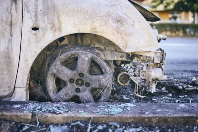 Close-up of damaged car on road