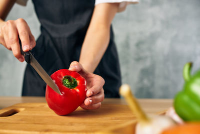 Midsection of man holding ice cream on cutting board