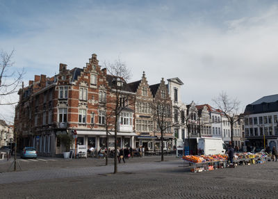 Buildings by street against sky at vrijdagmarkt