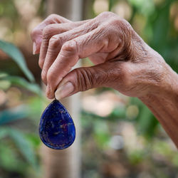 Cropped hand holding blue stone