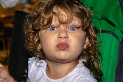 Close-up portrait of girl with curly hair