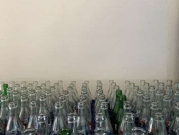 Close-up of wine bottles against wall