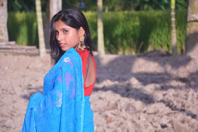 Portrait of woman standing on land