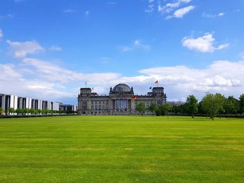 View of government building against cloudy sky