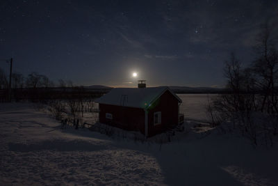 Scenic view of grassy field against sky at night