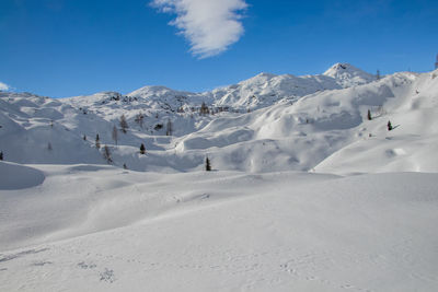 Scenic view of snow covered mountains against sky