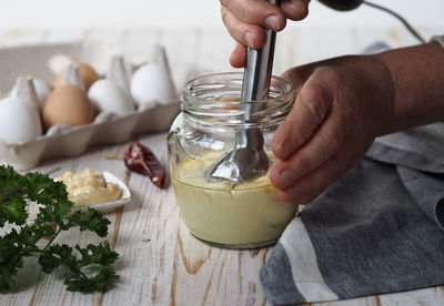 The concept of making homemade mayonnaise from natural healthy ingredients. an elderly woman 