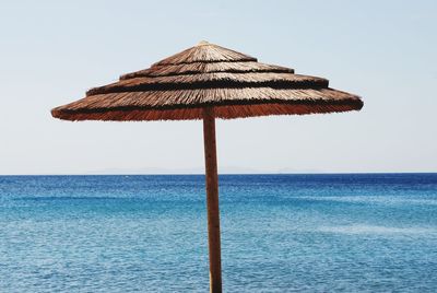 Lifeguard hut on beach against clear sky