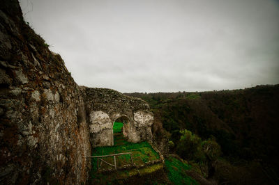 Panoramic shot of stone wall against sky