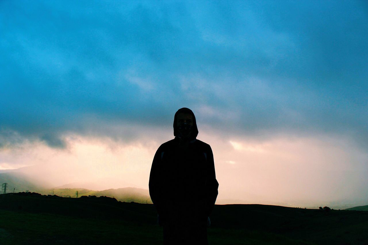 sky, silhouette, lifestyles, standing, rear view, cloud - sky, leisure activity, men, three quarter length, waist up, landscape, cloud, field, tranquility, nature, cloudy, tranquil scene, dusk