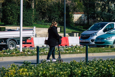 Woman with umbrella walking on street