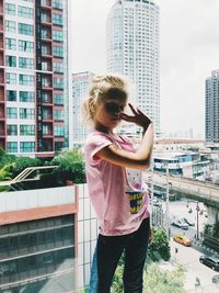 Man standing against modern buildings in city