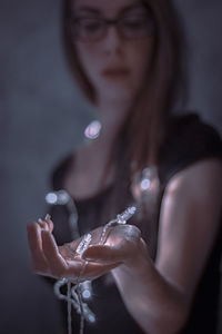 Close-up portrait of a young woman holding hands