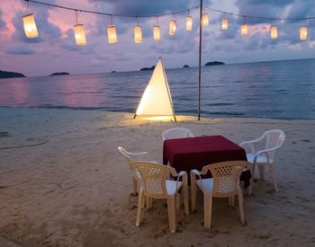 Table on beach at sunset