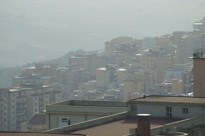 Buildings in city against sky