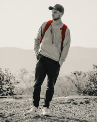 Full length of man standing on field against sky