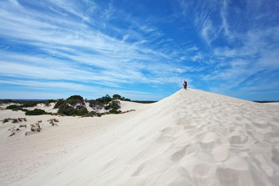 Scenic view of desert against blue sky