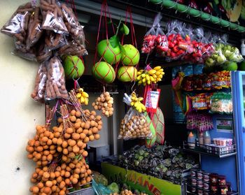 Various fruits hanging on market stall