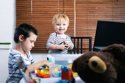 Portrait of cheerful boy playing at home