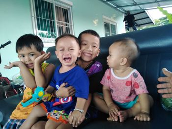 Portrait of smiling friends sitting outdoors