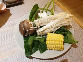 High angle view of vegetables in plate on table