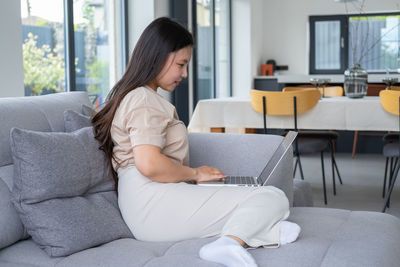 Young woman shopping online at home