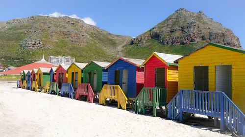 Multi colored beach huts at shore