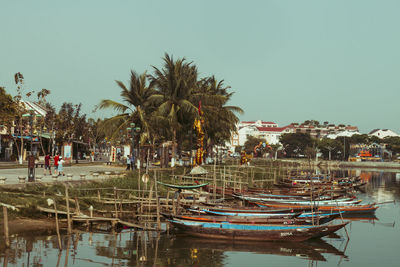 Boats moored in swimming pool against sky