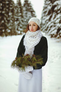 Portrait of woman standing in snow