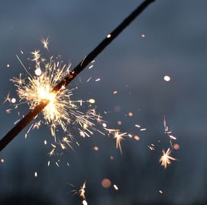 Low angle view of firework display in sky at night