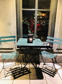 Potted plants on table by window of building