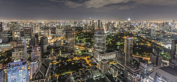 High angle view of illuminated cityscape against sky at night