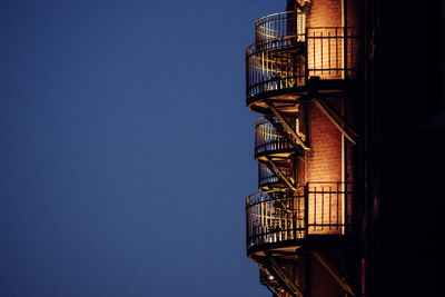 Low angle view of fire escape against clear sky