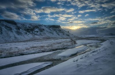 Scenic view of snow covered landscape against sky