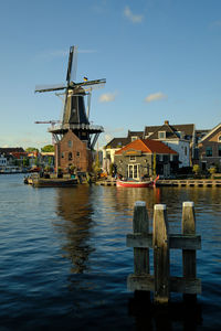 The famous adriaan windmill on the river de spaarne on a clear day in haarlem, the netherlands.