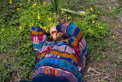 Moroccan man laying on the ground with his hand over his face