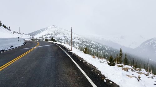 Road passing through snow covered mountain