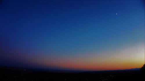 Scenic view of landscape against blue sky at night