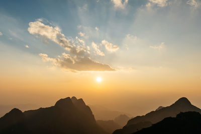 Scenic view of silhouette mountains against sky during sunset