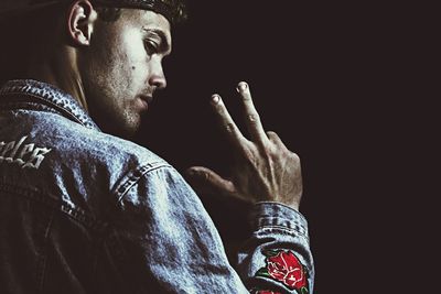 Close-up of hands against black background