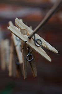 Close-up of clothespins hanging on rope