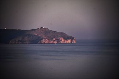 Scenic view of sea and mountains against sky