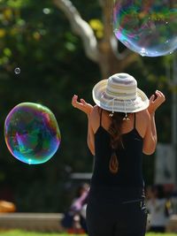 Reflection of young woman in bubbles